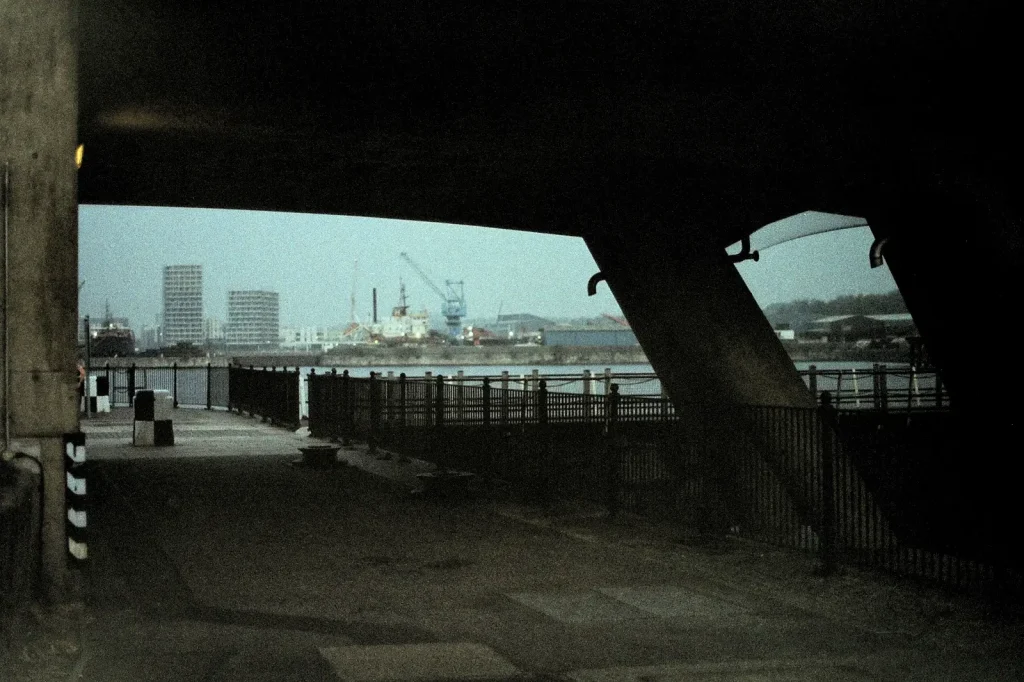 a photograph of a scene through a bridge