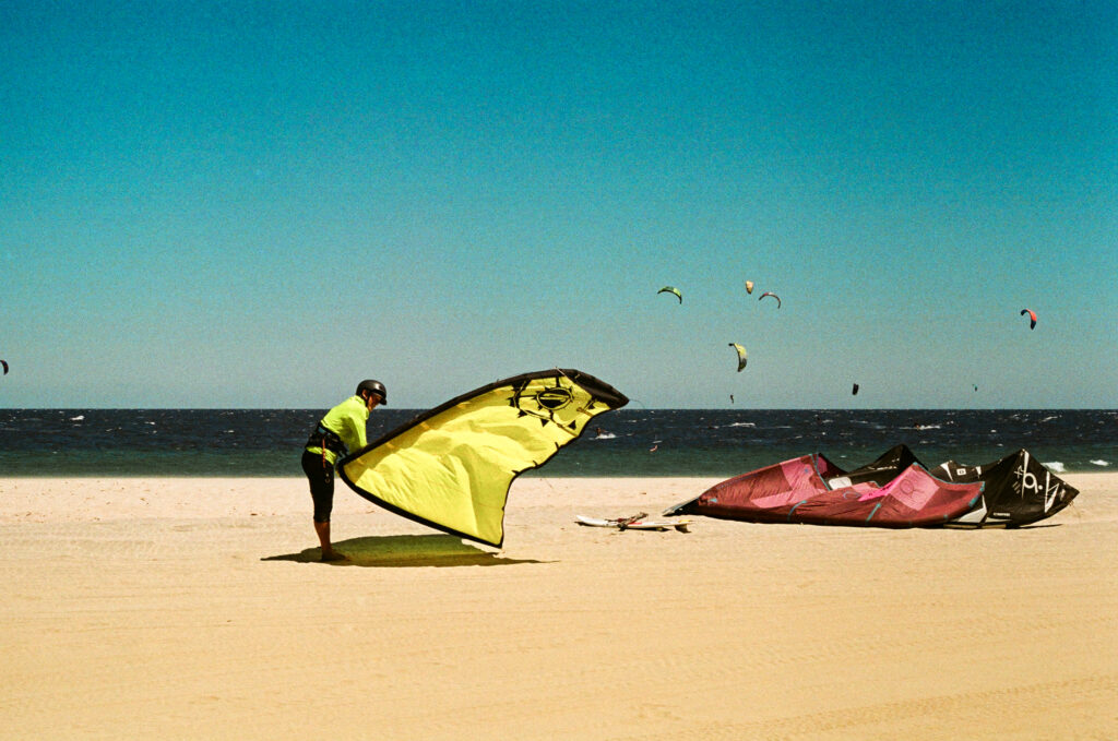 Kite surfer preparing their equipment on a beach
