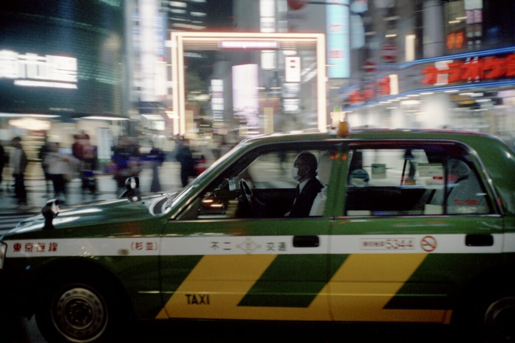 Taxi zooming through Shinjuku