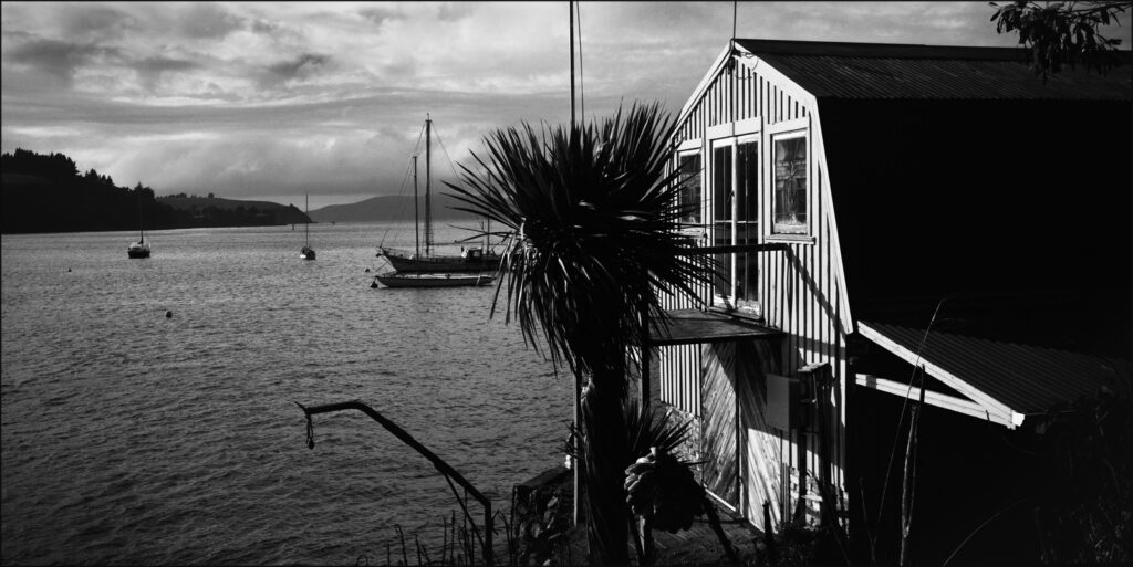 A boat house in Deborah Bay along the harbour from Port Chalmers with views to the harbour mouth and Pacific.