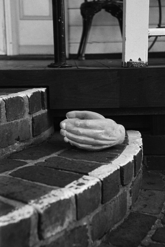 Ceramic sculpture of hands on a step