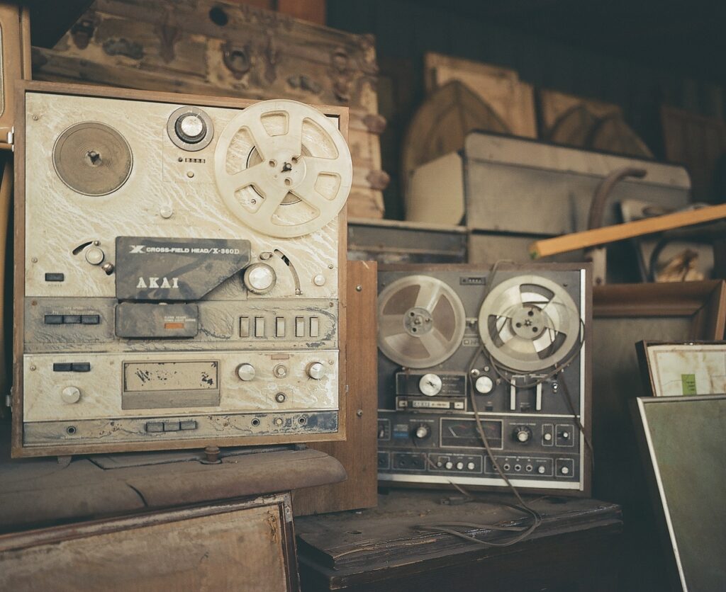 Junked reel-to-reel tape players.