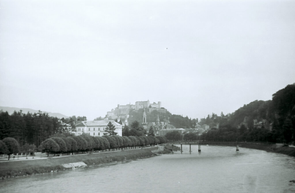 A black-and-white view of the old town of Salzburg and the castle.