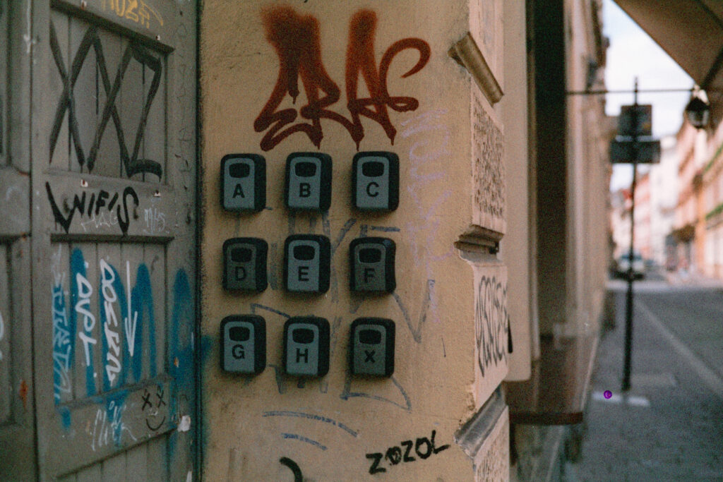 Key lockboxes next to a graffiti covered wall in Krakow