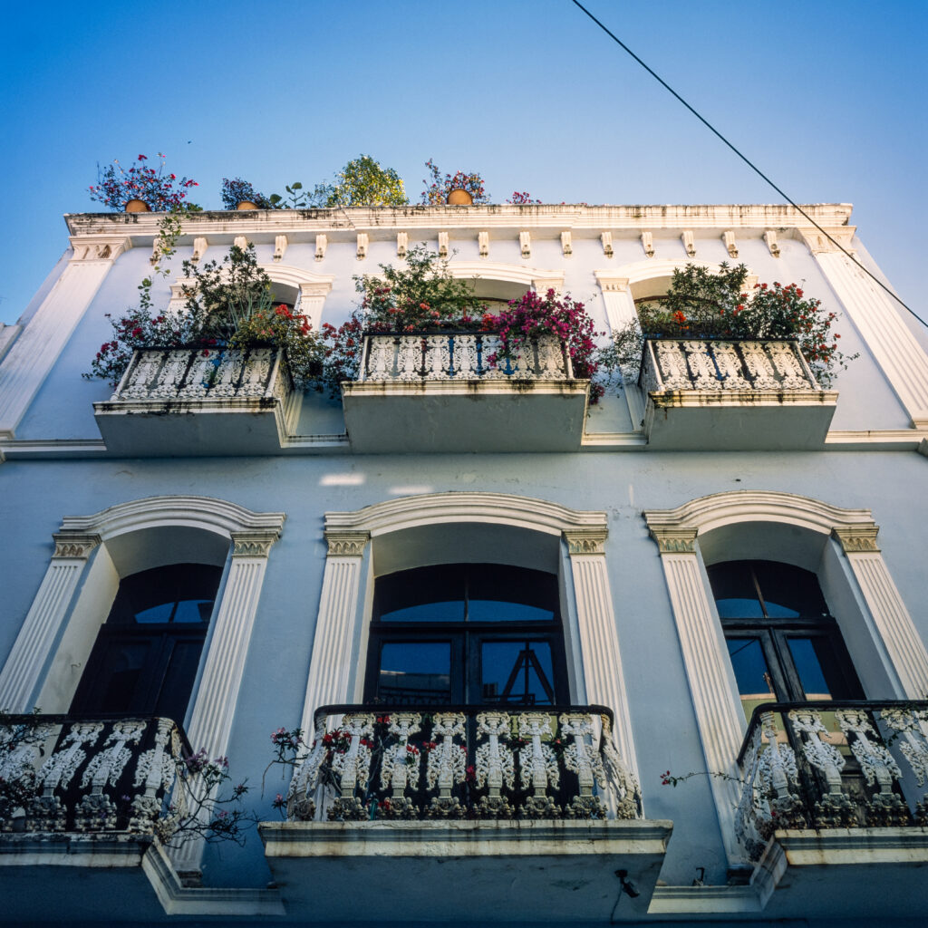 Upward shot of house with balconies and plants