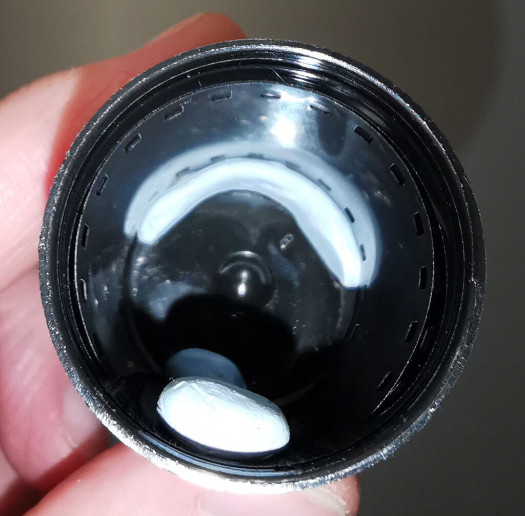 Inside of film pot showing use of blu-tack to position film correctly