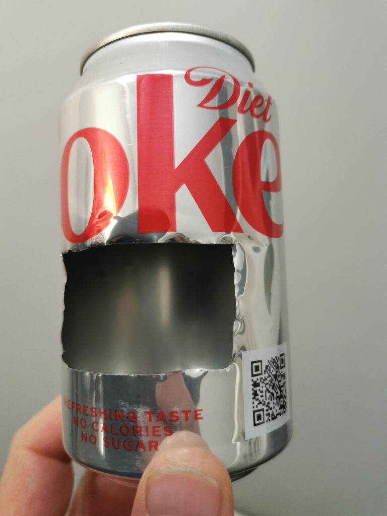 Coke can with section of foil cut out