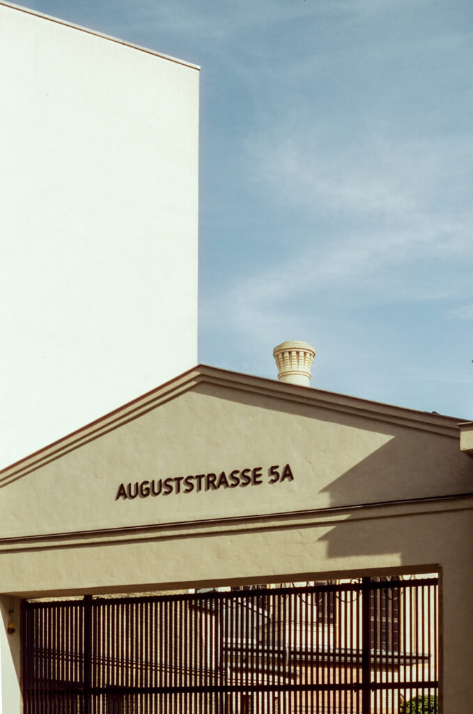 Wispy clouds drift about a chimney in Berlin