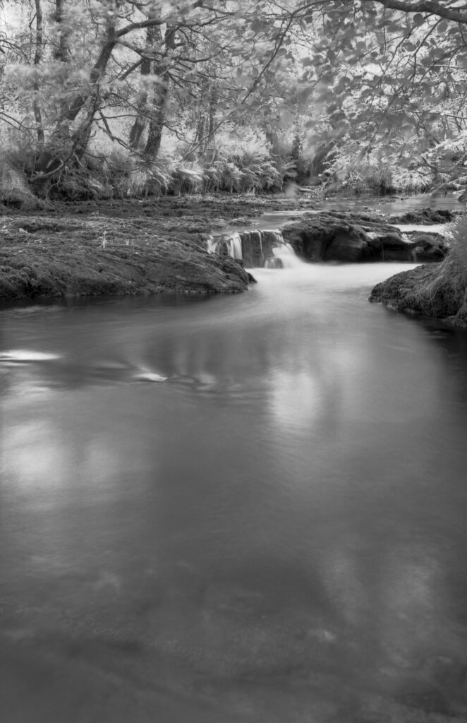 Black and white image of a river flowing.