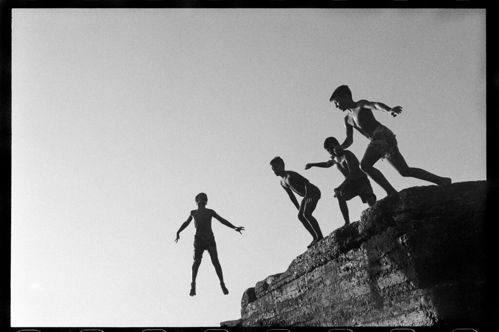 Kids jumping in the sea