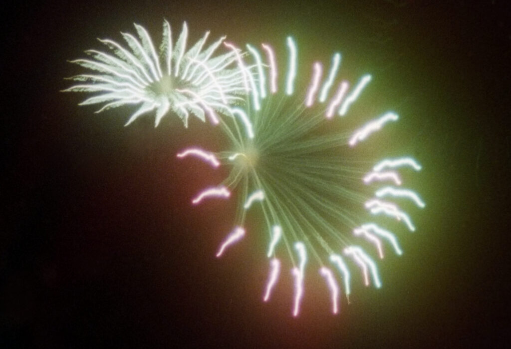 Fireworks flowers through a breath-steamed lens