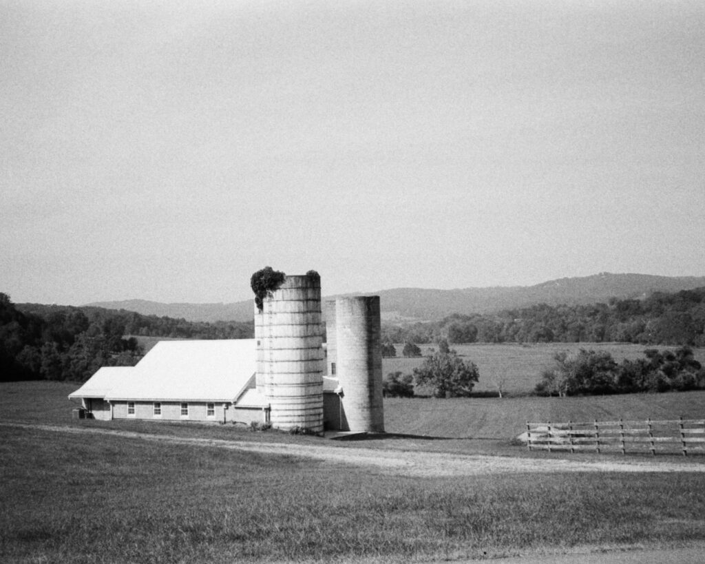 Photo of barn with mountains in background