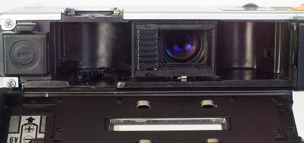 Back open showing battery at left and film chamber lacking a film speed sensor.