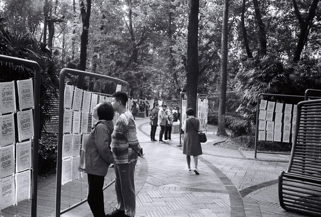 A man and a woman reading notices