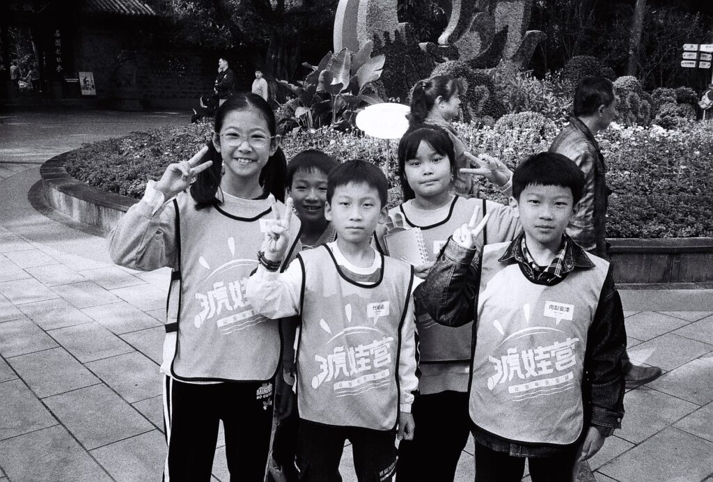 A close up of 5 children posing for the camera.