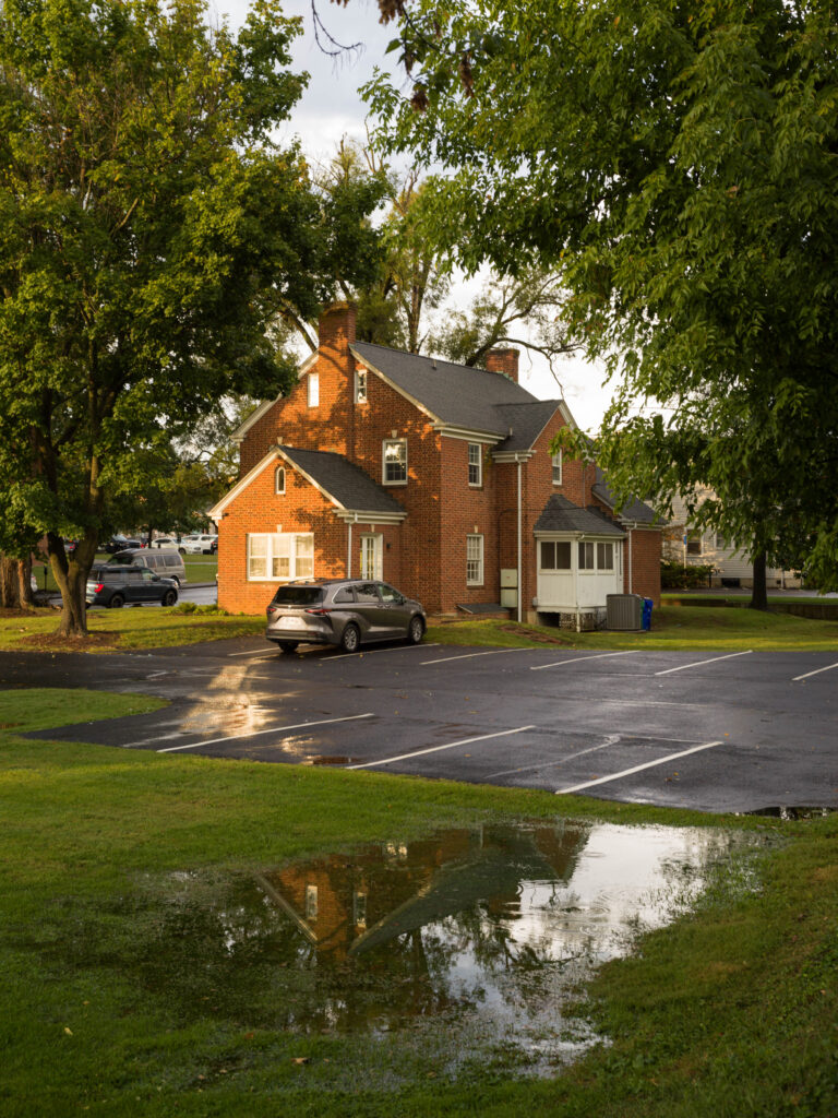 Building reflected in puddle