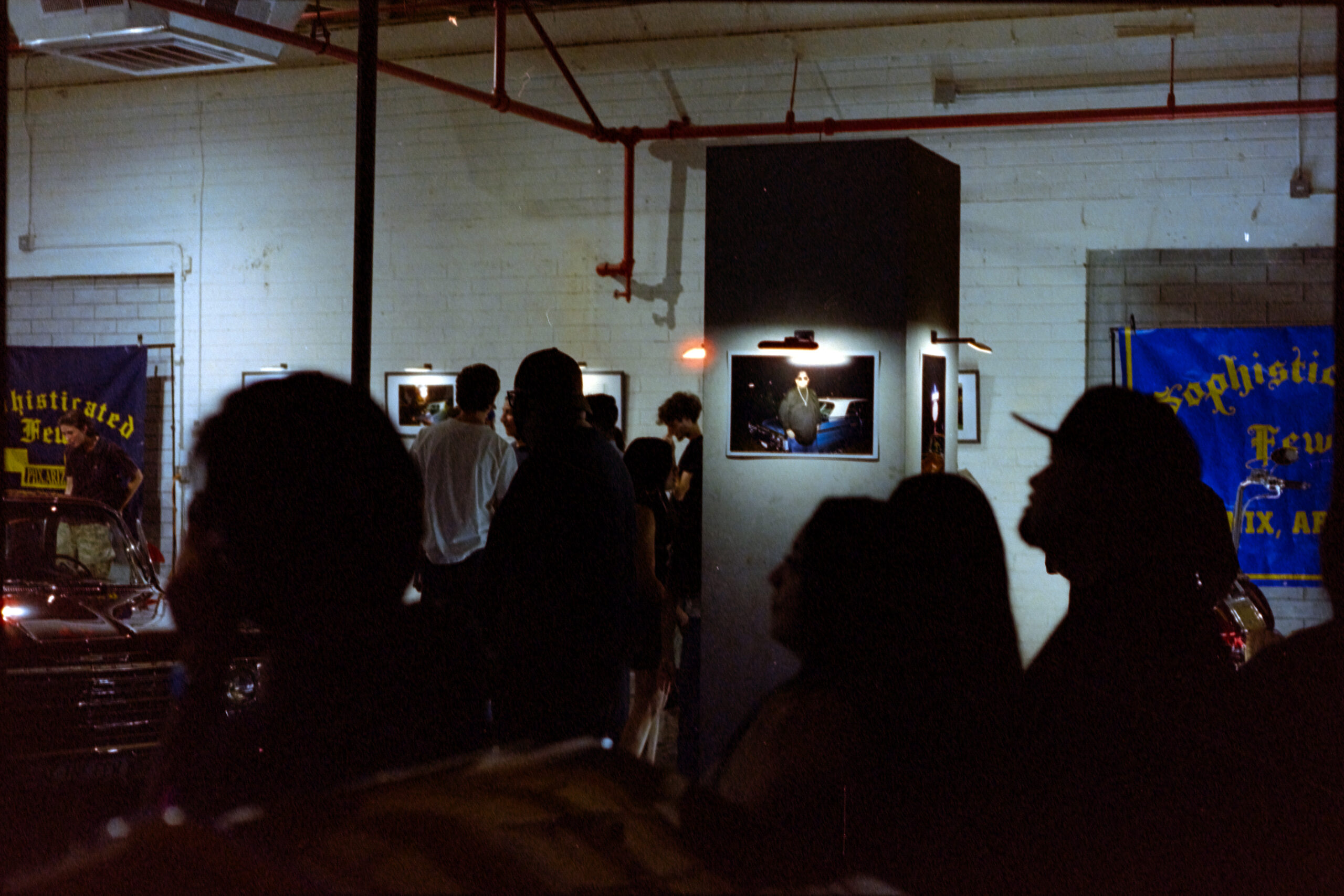 A crowd of people at a gallery exhibition