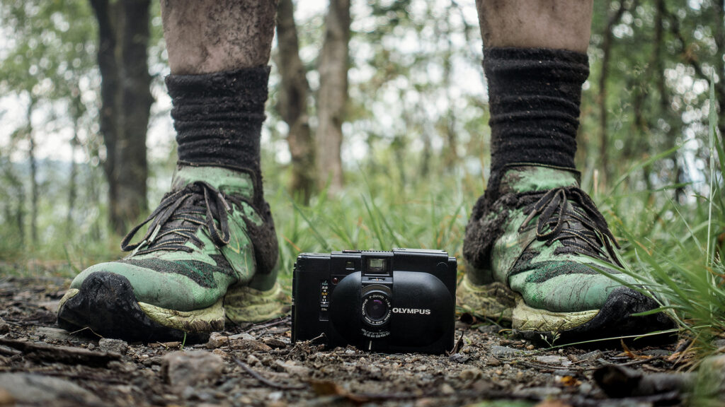 The elegant Olympus XA and my muddy shoes after 16km on wet mountain trails.