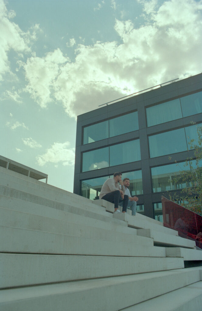 Two guys sitting on stairs at the harbour in Offenbach/Germany