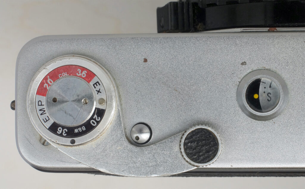 Detail of wind lever with frame counter and rewind button/winding indicator.