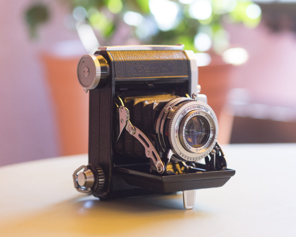 Color photo of a Konica Pearl III medium format folding camera.