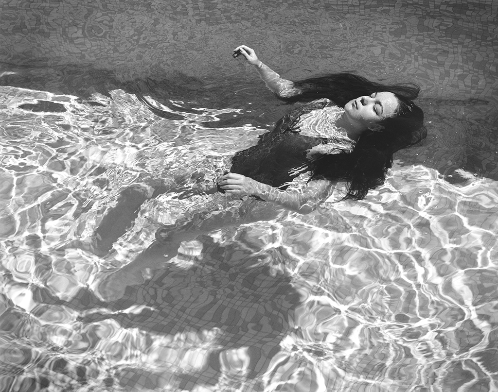 Girl floating in pool