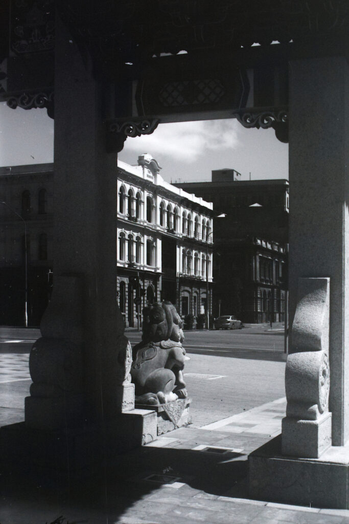 One of Dunedin's restored commercial building seen through the entrance arch to the Chinese Gardens,