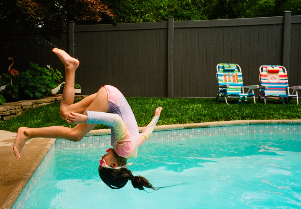 Girl jumping into pool