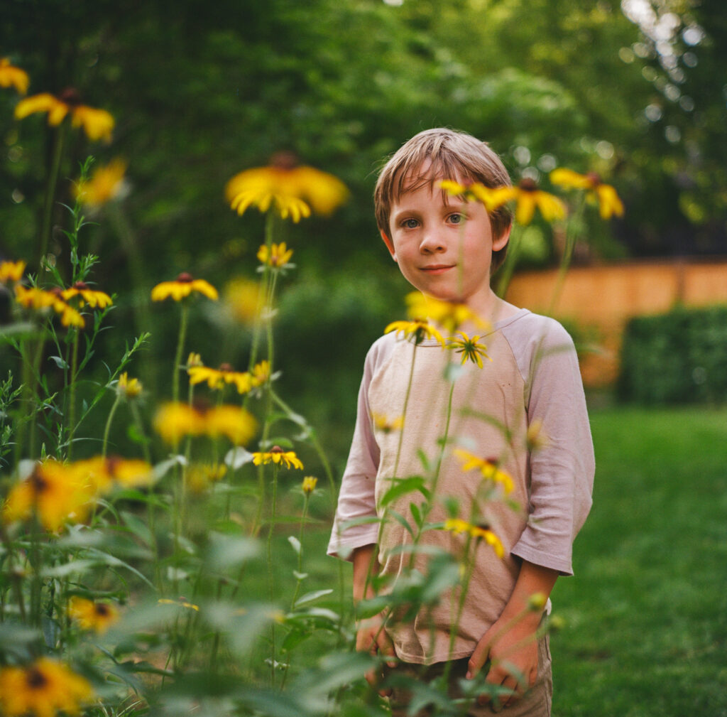 Boy by flowers