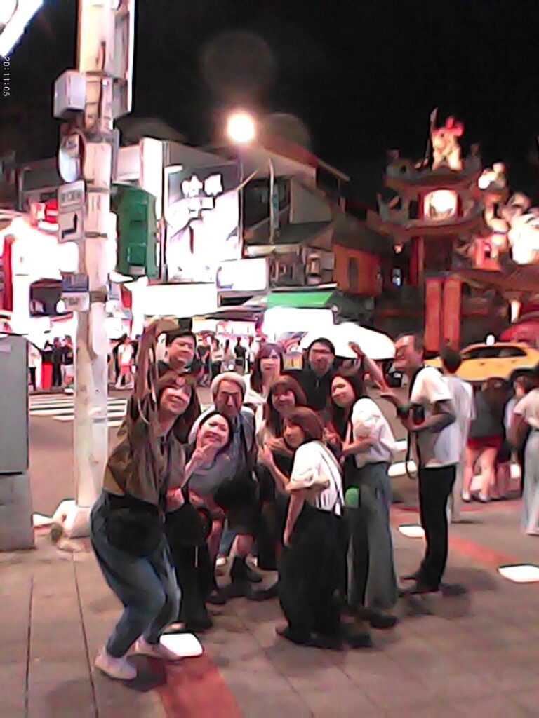 Japanese Tourists at Raohe Night Market taking a group photo.