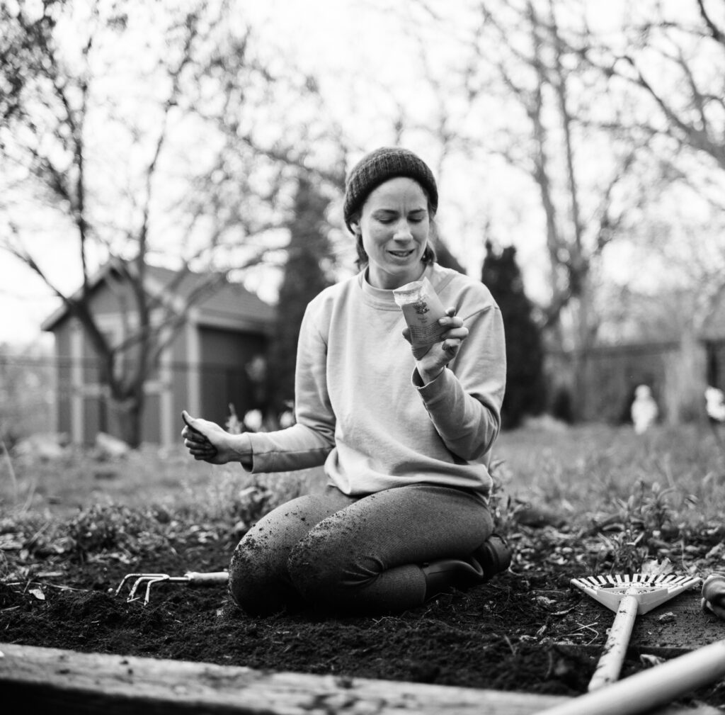 woman looking at seed pack