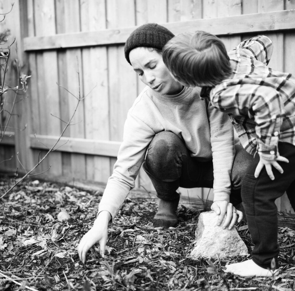 Boy kissing mother in garden