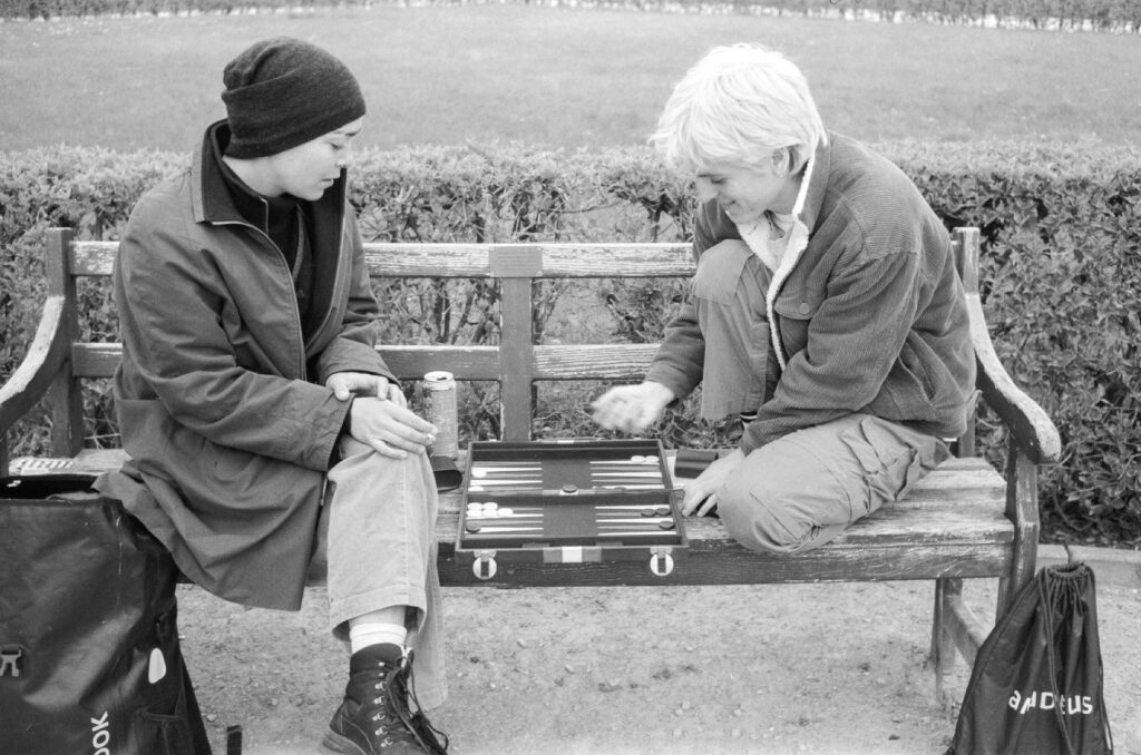 Young people playing backgammon in the park