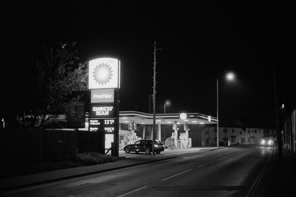 A petrol station at night- black and white.