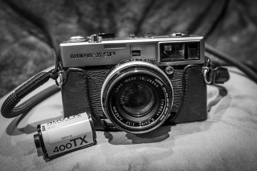 Olympus 35SP camera with a roll of film.