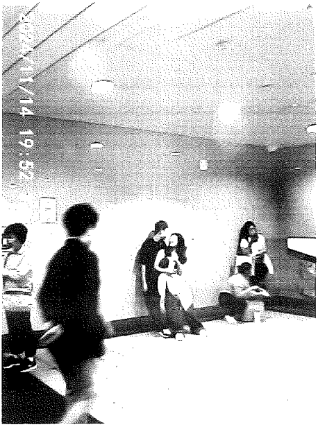 A couple waits in the station entrance for the rain to stop.