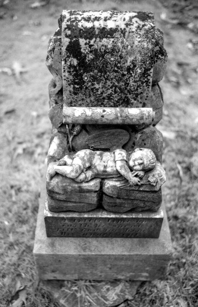 sculpted baby on grave marker 