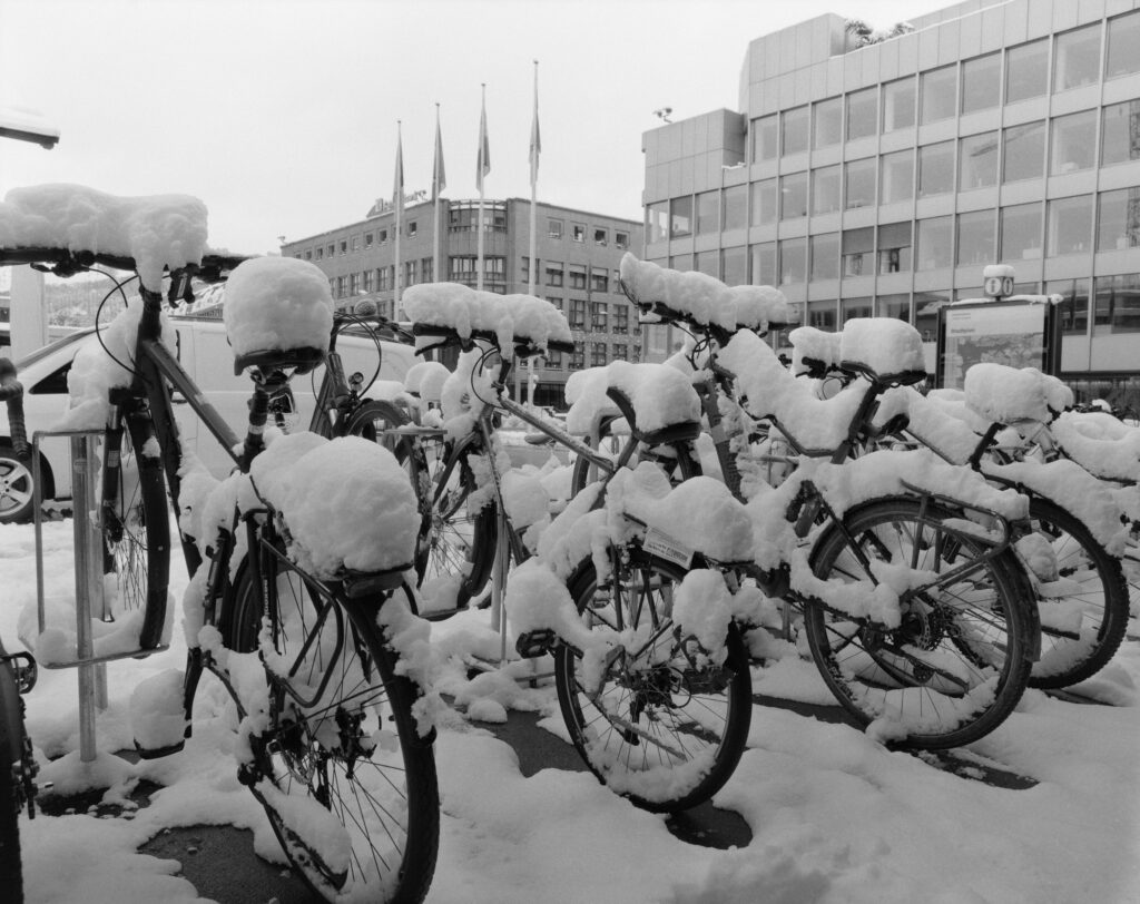 Snow buildup on bicycles outside Office