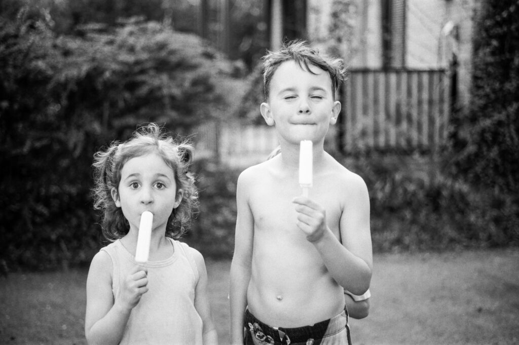 Boy and girl eating popsicles