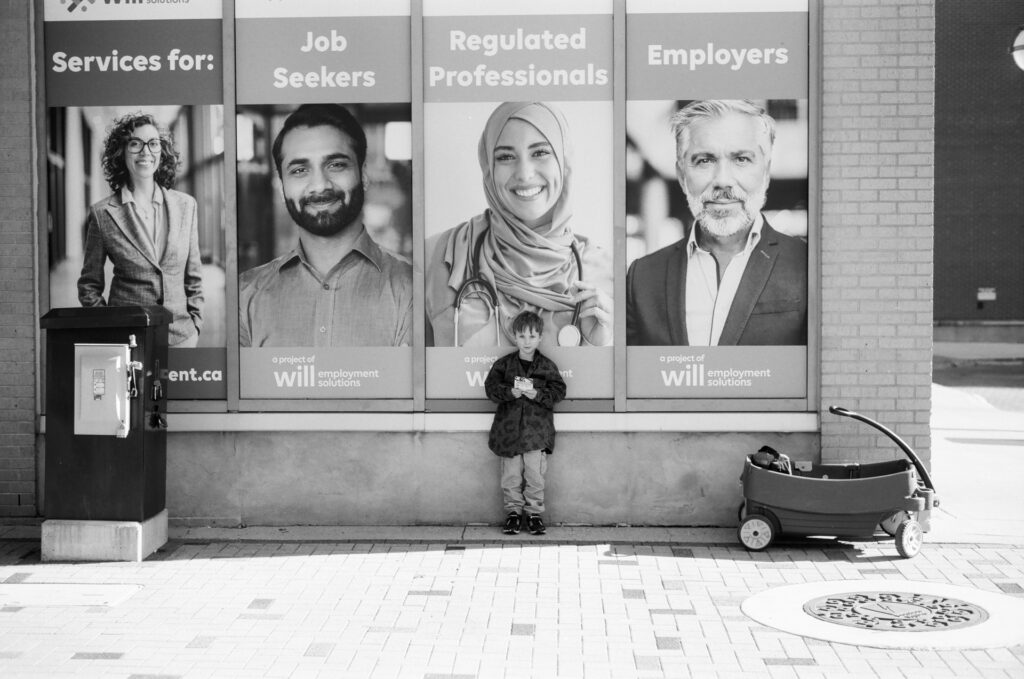 Boy standing in front of advertisement