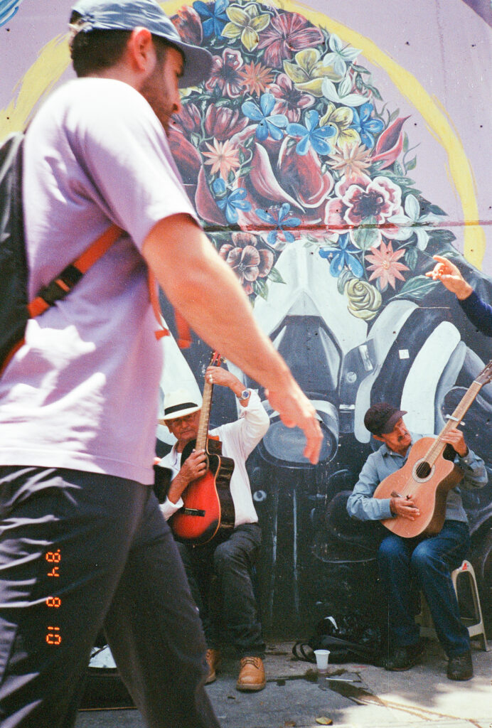 Color photograph of 2 guitar players in Comuna 13, Medellin, Colombia