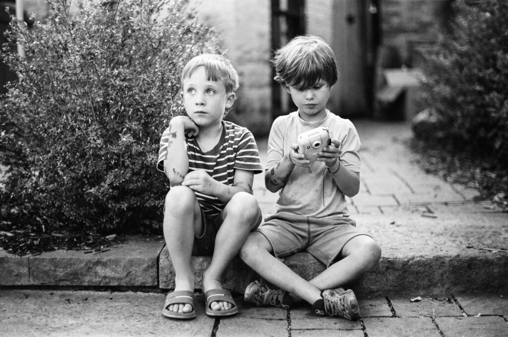 Two boys sitting in garden