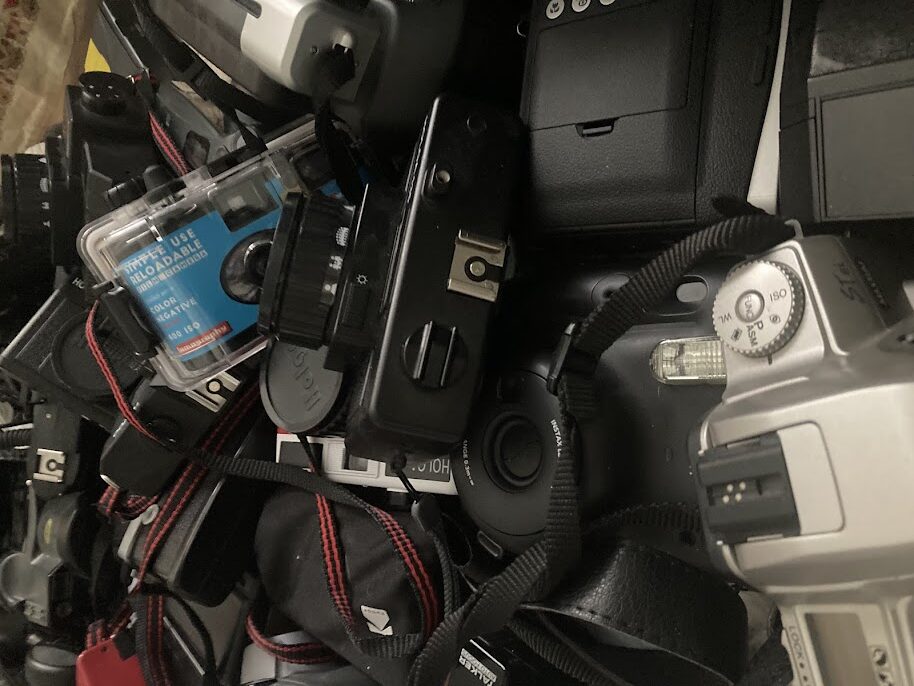 a jumble of a variety of film, digital, and instant cameras