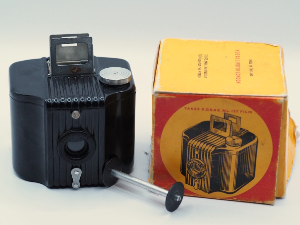 a black bakelite box camera and its box.